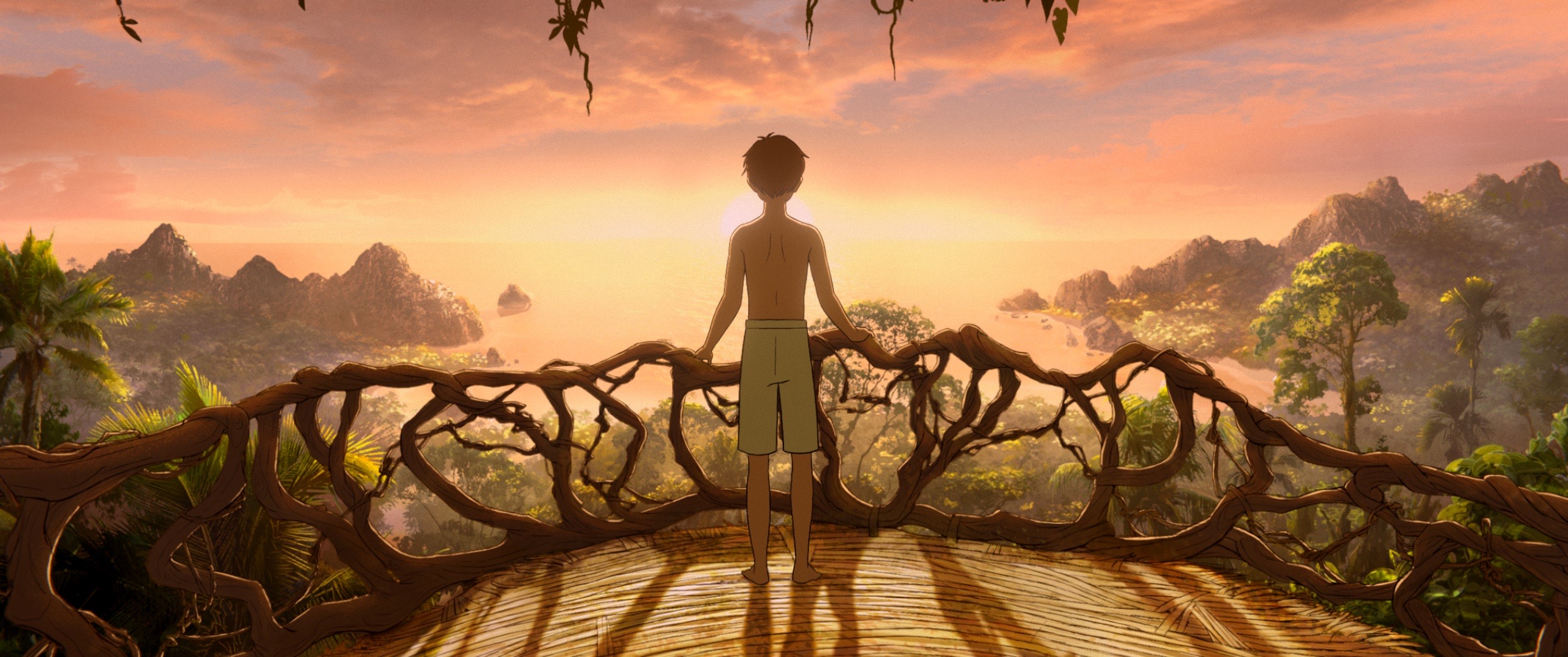 Production shot from Kensuke's Kingdom of boy in shorts overlooking a mountain range at sunset